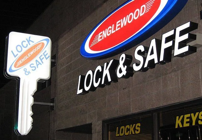 Illuminated oval business logo and dimensional storefront lettering