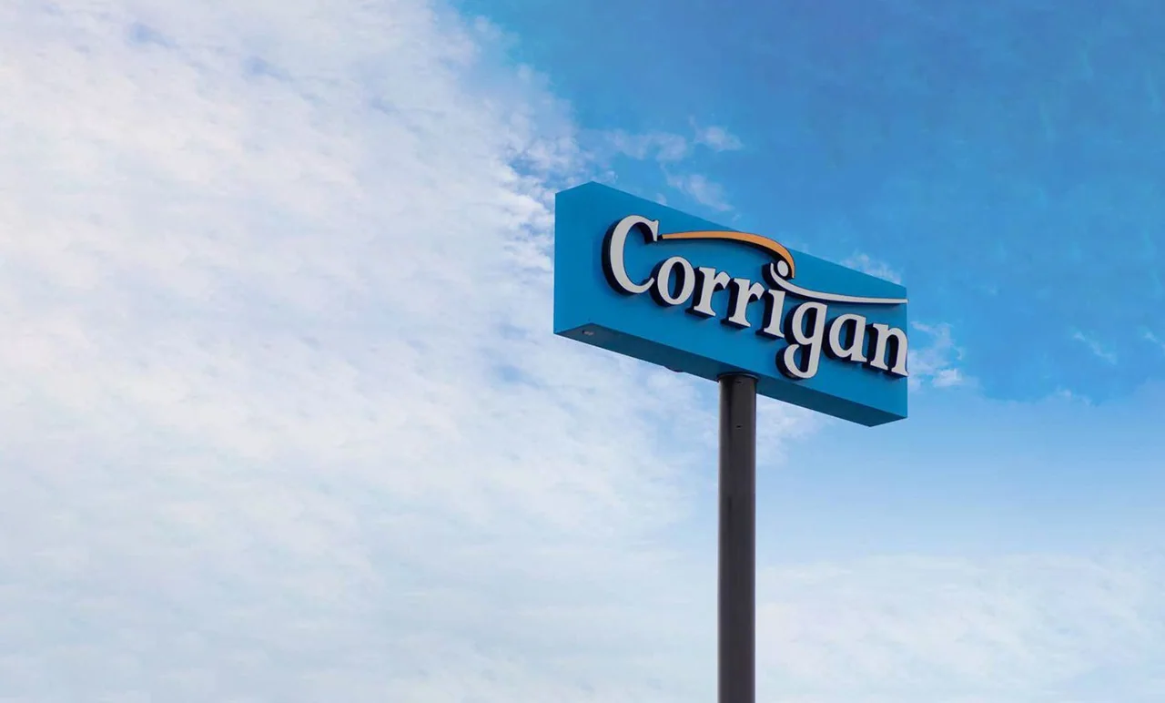 Blue double-sided business sign elevated on a single support